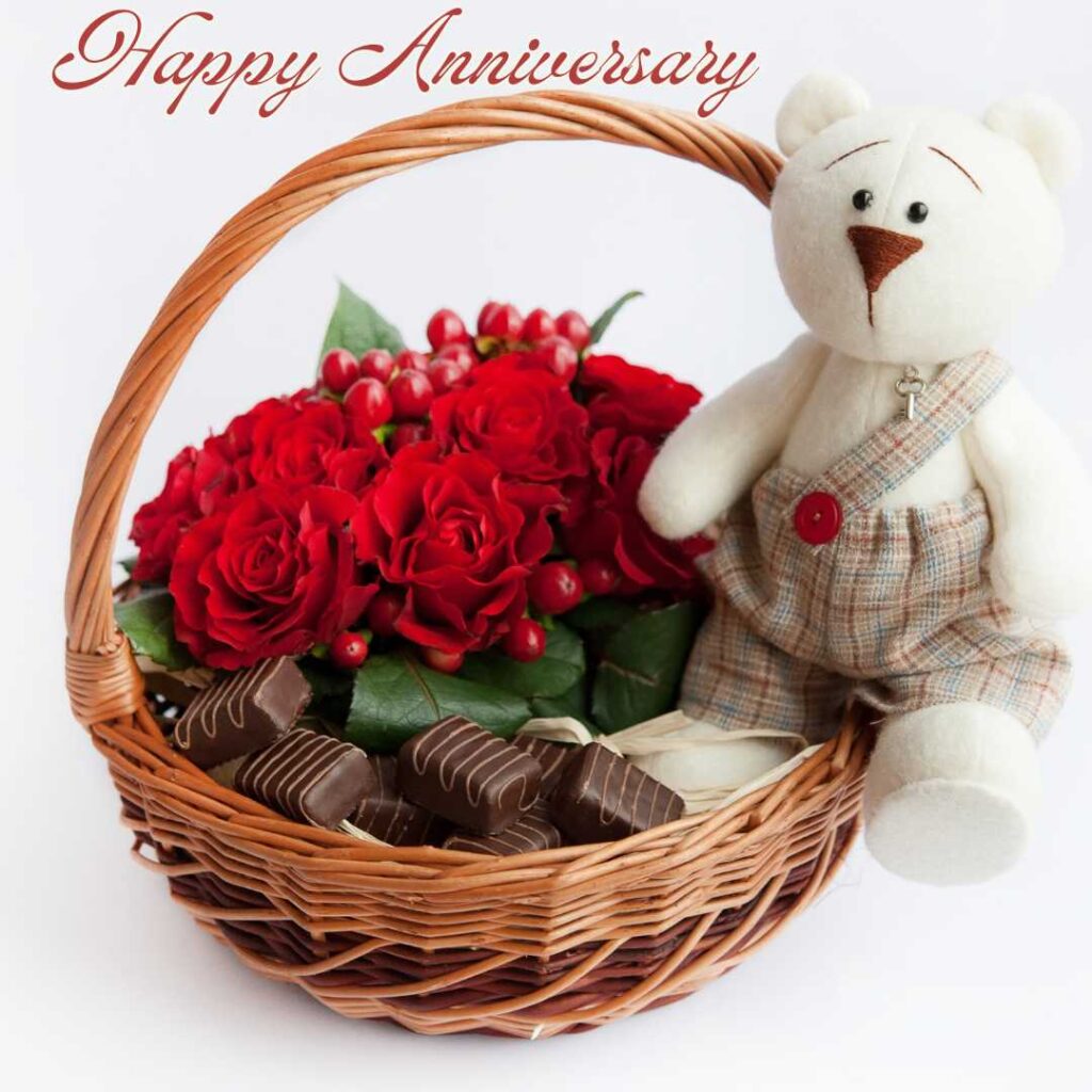 Happy-Anniversary-A-basket-filled-with-flowers-and-chocolates-with-teddy-bear-as-a-gift-for-your-love