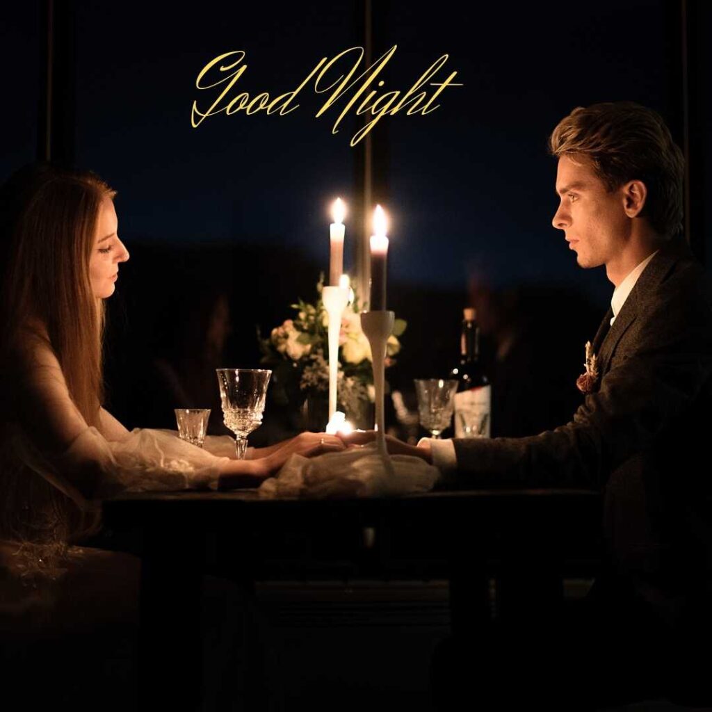 Good-Night-The-couple-enjoy-a-candle-light-dinner-holding-each-others's-hands